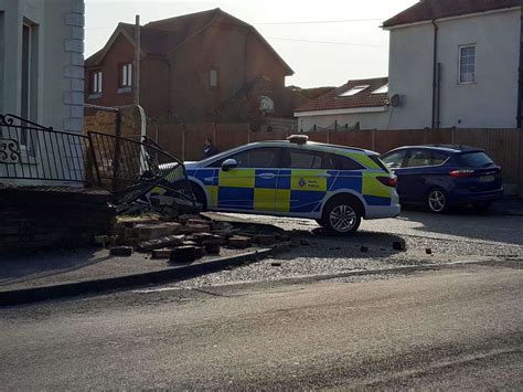 Police Car Crashes In Deal Into House Railings And Wall