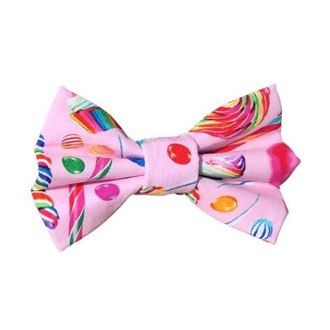 A Pink Bow Tie With Candy And Lollipops Printed On The Front Side