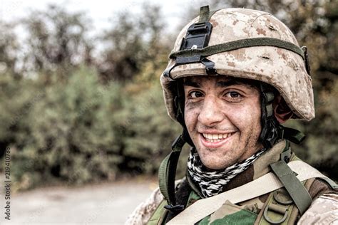 Shoulder Portrait Of Happy Smiling Young Soldier In Battle Helmet With