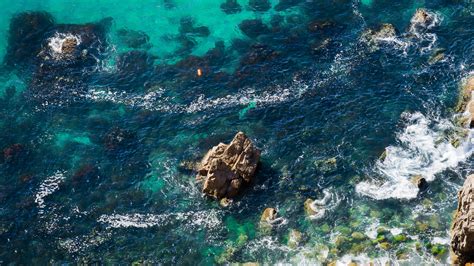 Download Wallpaper 2560x1440 Sea Coast Aerial View Water Stones