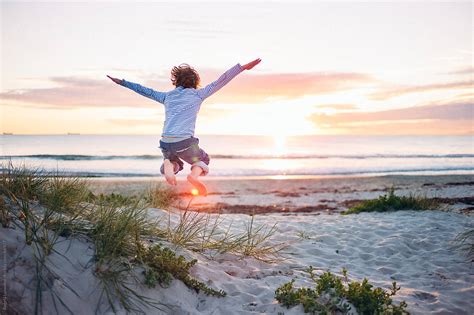 Boy Jumping At The Beach At Sunset By Stocksy Contributor Angela Lumsden Stocksy