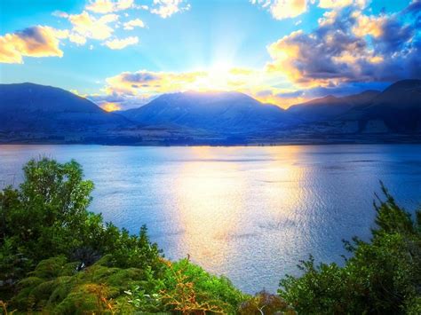 Relaxing Landscape With Water Mountains And Sunlight Wallpaper