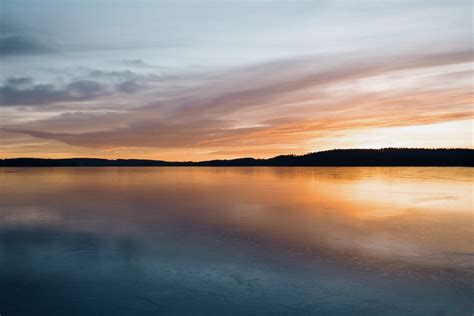 Calm Body Of Water Near Mountain During Golden Hour Photo Free Sweden