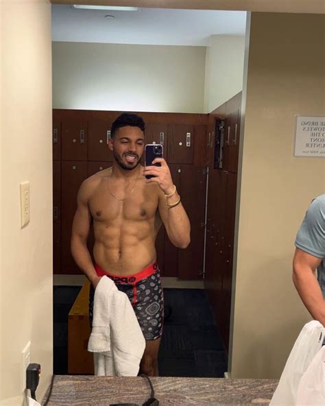 A Shirtless Man Taking A Selfie In The Bathroom