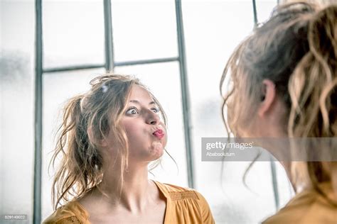 Redhead Woman Making Faces In Mirror Paris France High Res Stock Photo