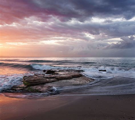 Stormy Orange Beach Sunrise At Playa De La Misericordia Spain Beach