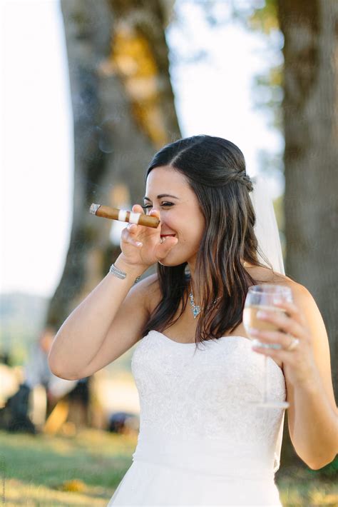 Bride Holding Glass Of White Wine And Smoking Cigar By Leah Flores