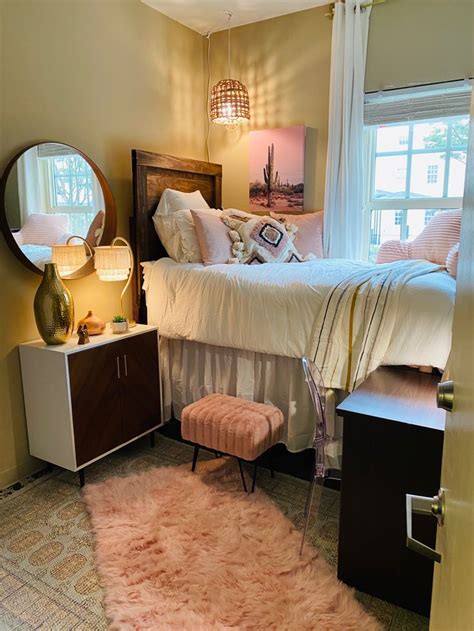 A Bed Room With A Neatly Made Bed And A Pink Rug