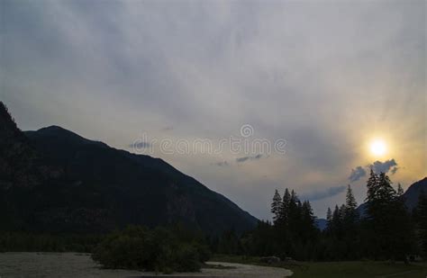 Storm Dark Clouds Over Mountain River Valley With Grass And Rocks Stock
