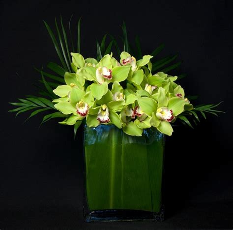 This Is A Floral Arrangement That Features Green Cymbidium Orchids Arreglos Florales