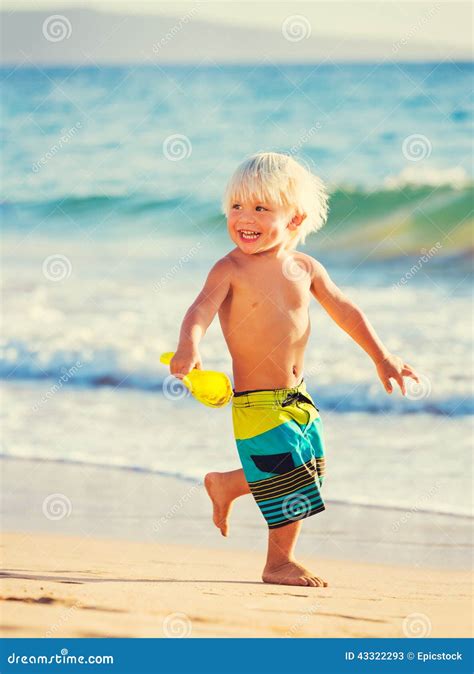 Menino Novo Que Joga Na Praia Imagem De Stock Imagem De Funcionar