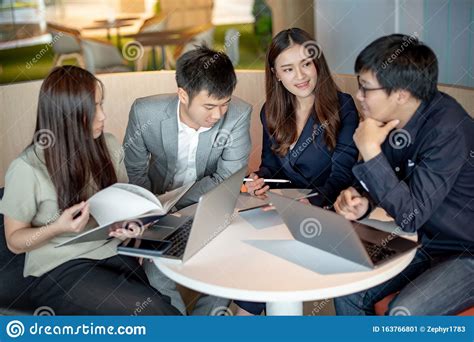 Asian Colleagues Discussing At Workplace Stock Image Image Of Group