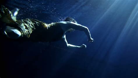 Beautiful Woman Swimming Under Water In Clothes Stock