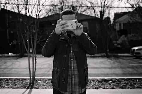 Man taking photo on mobile phone on street · Free Stock Photo