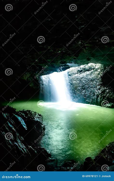 Shiny Waterfall Flows In The Dark Stone Cave Stock Image Image Of