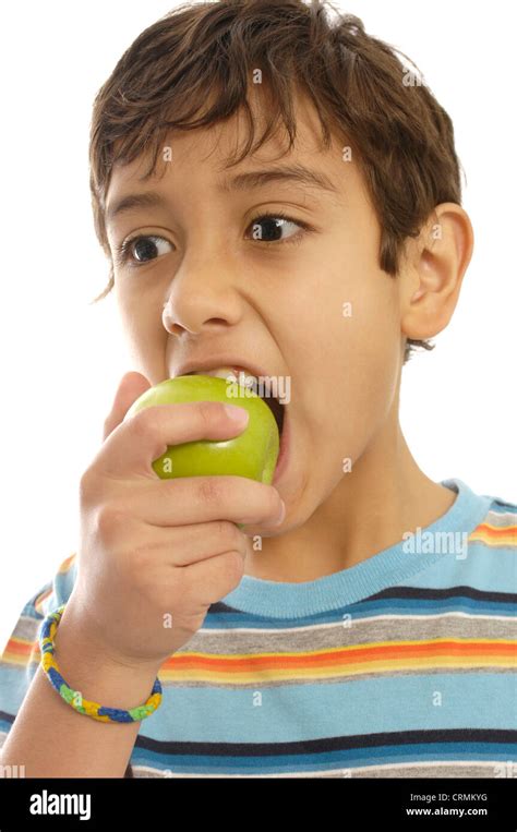 A Young Boy Eating An Apple Stock Photo Alamy