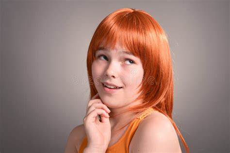 Portrait Of Cute Girl With Red Hair Posing In Studio Stock Photo