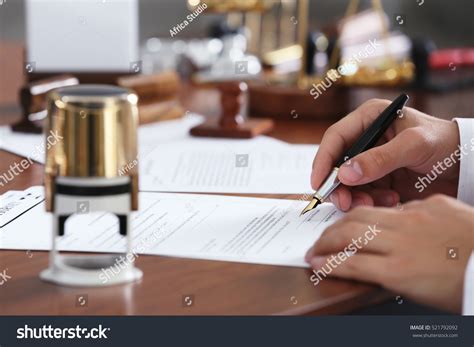 Notary Public In Office Signing Document Stock Photo