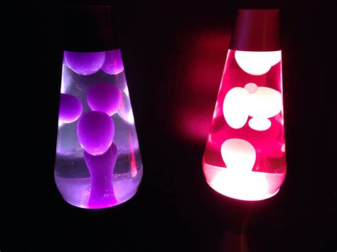 two sixteen inch lava lamps one with purple wax and clear liquid and the other with white wax