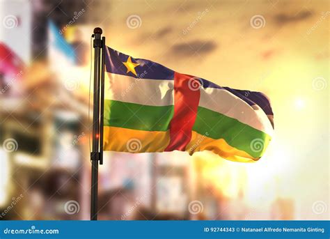 Central African Republic Flag Against City Blurred Background At Stock