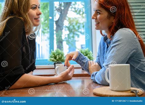 Lesbian Couple Of Women On A Date In A Cafe Two Gay Girlfriends Hold Hands And Flirt In A