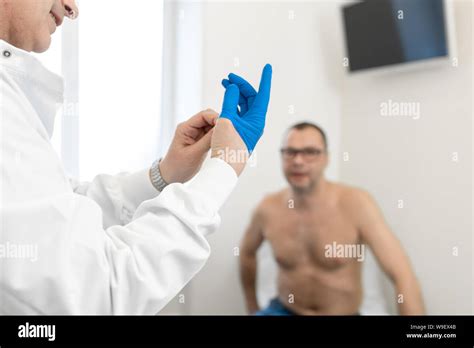 Doctor Urologist Puts A Medical Glove On The Arm To Examine The Patient S Prostate Prostate