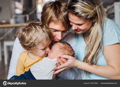 Young Parents With Newborn Baby And Small Toddler Son At Home — Stock