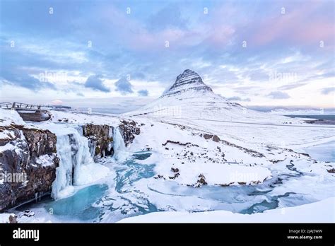 The Frozen Waterfall Of Kirkjufellfoss In Iceland In Winter Covered In