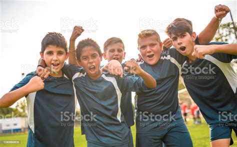 Portrait Of Celebrating Teenage Boy Footballers Stock Photo Download