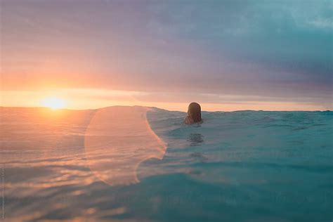 Young Girl Swimming Alone At Sunset By Stocksy Contributor Alison