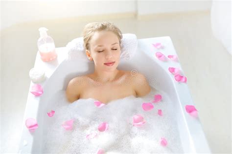 Attractive Girl Relaxing In Bath On Light Background Royalty Free Stock