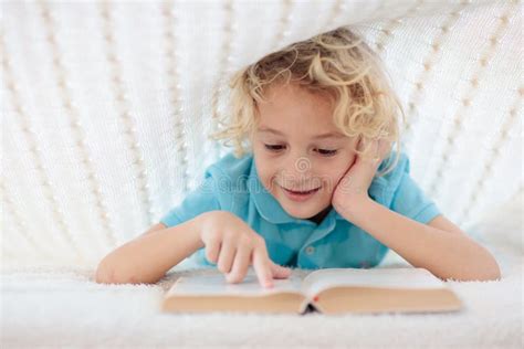 Child Reading Book In Bed Kids Read Books Stock Image Image Of