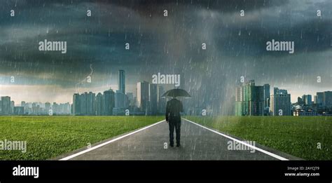 Businessman Below Storm Rain With Umbrella Stock Photo Alamy