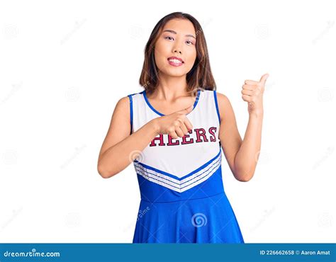 Young Beautiful Chinese Girl Wearing Cheerleader Uniform Pointing To