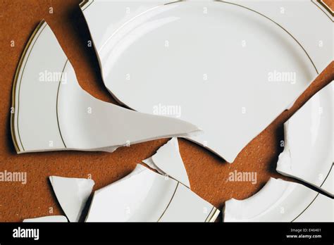 A Broken Plate Lying On A Red Floor Stock Photo Alamy
