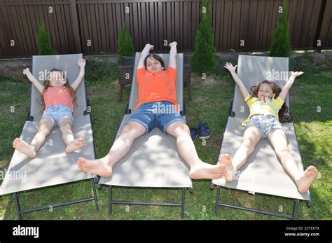Tickle Time A Brother And His Two Sisters Spend Time Together In The Sunny Outdoors And Have
