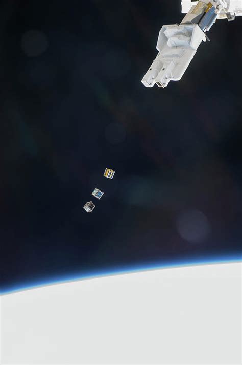 Iss Deploying Satellites Photograph By Nasa Fine Art America