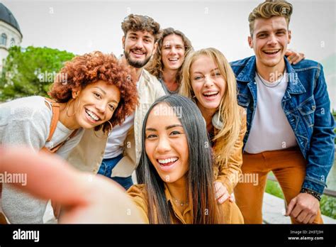 Multiracial Happy Friends Having Fun And Laughing Together Outdoors Taking Selfie Portrait On