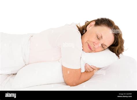 Mature Woman Hugging Pillow While Sleeping On Bed Stock Photo Alamy