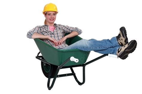 Construction Worker Sitting In A Wheelbarrow Photo Background And