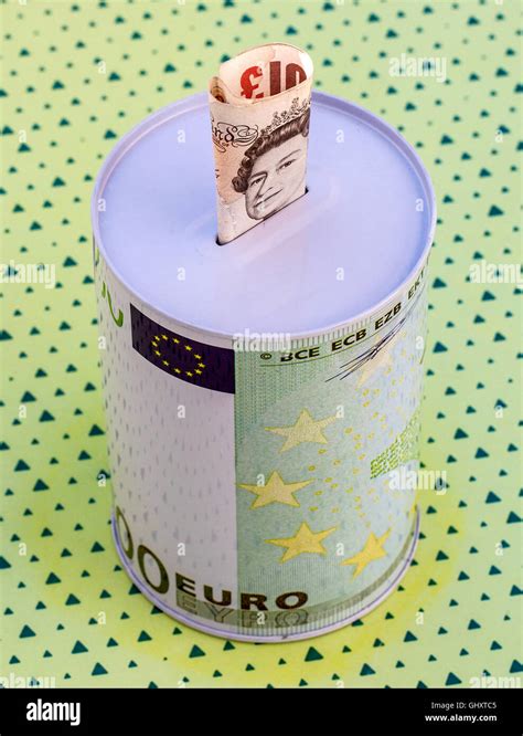 Money Saving Box With Euro Printing And Sterling Into The Box Stock