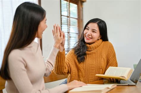 Charming Asian Female College Student Giving High Five To Her Best