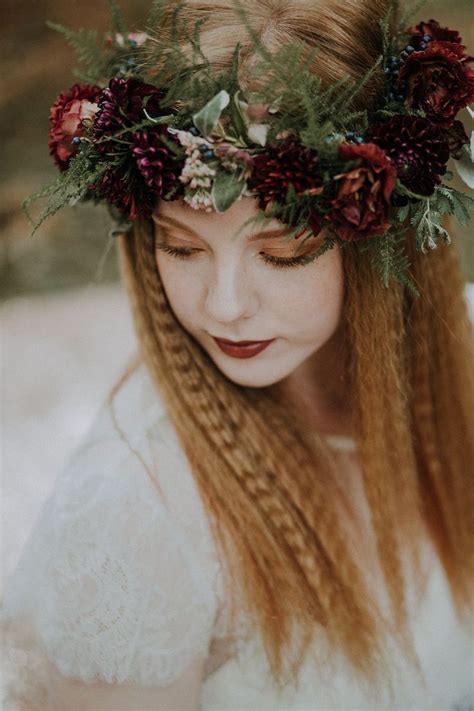 A Woman With Long Red Hair Wearing A Flower Crown On Her Head And