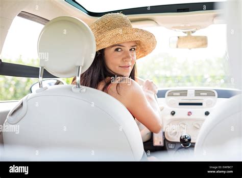 Beautiful Woman Looking Back While Driving Car Stock Photo Alamy