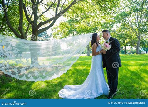 Happy Newlywed Couple Facing Each Other Holding Hands Bride And Groom