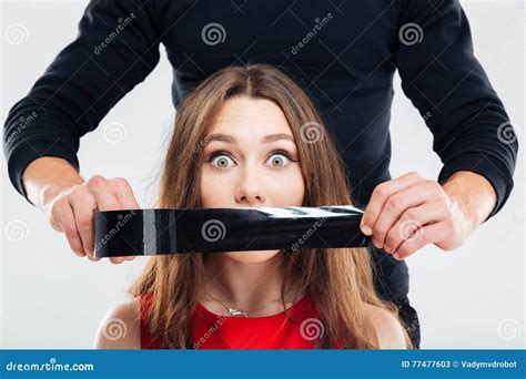 Closeup Of Man Covering Woman Mouth By Black Tape Royalty Free Stock