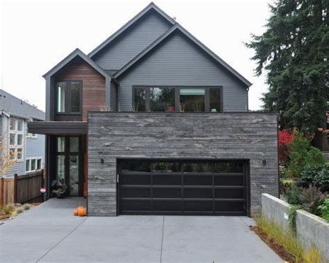 Gorgeous home features a three vehicle garage accented with black garage doors as well as apartment over garage. Exterior Design, Contemporary House Facade With Black ...