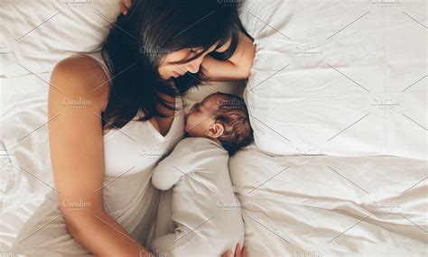 mother and son sleeping together high quality people images ~ creative market