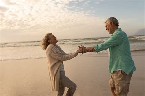 Active Senior Couple Dancing Together On The Beach Stock Photo Image