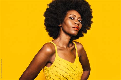 Beautiful Afro Woman Posing Over Yellow Background By Victor Torres
